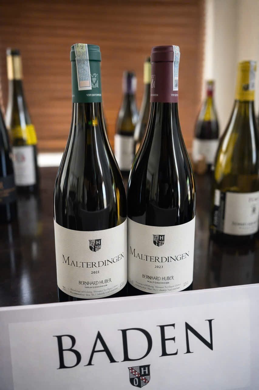 Two bottles of Bernhard Huber Malterdingen behind a Baden region card