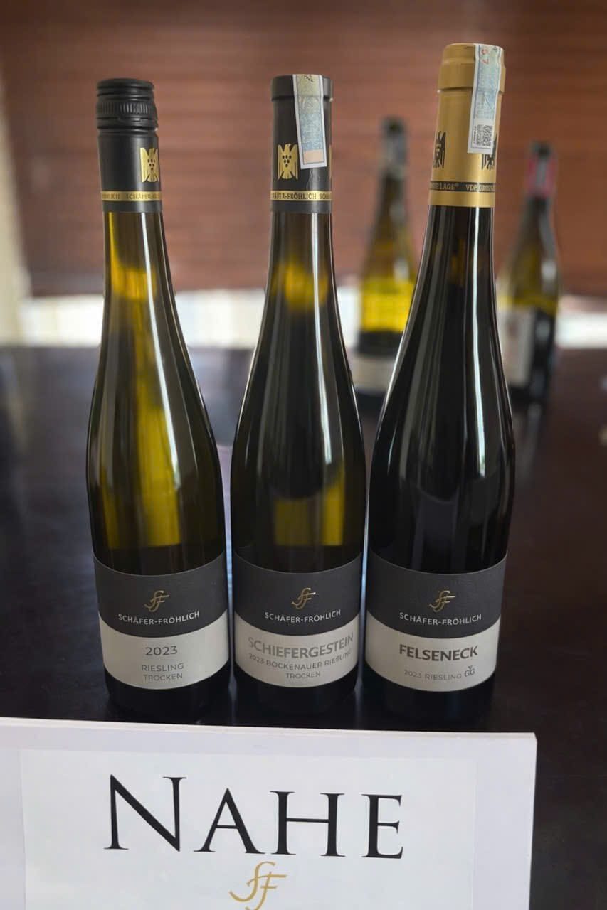 Three Schäfer-Fröhlich Riesling bottles behind a Nahe region card