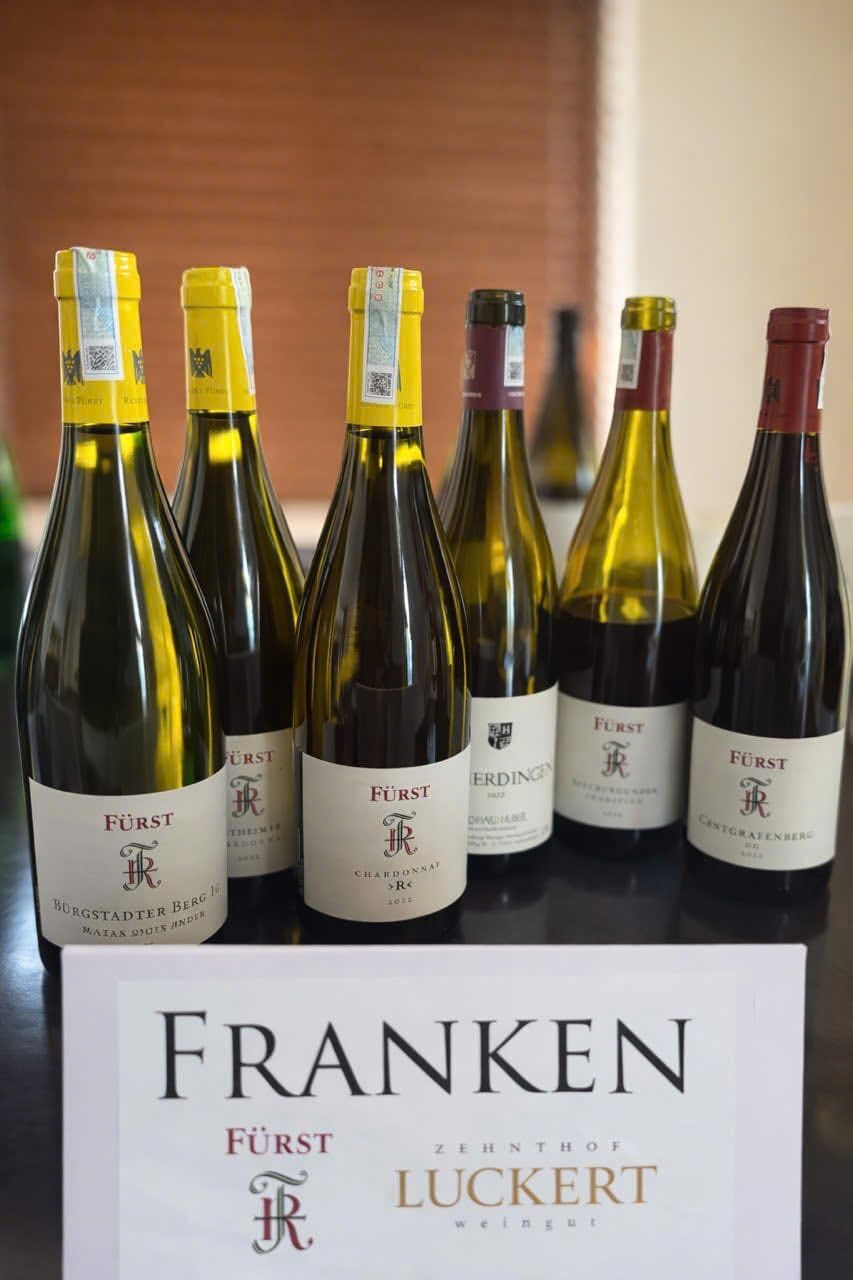 Bottles of Rudolf Fürst wine behind a Franken region card naming Fürst and Zehnthof Luckert