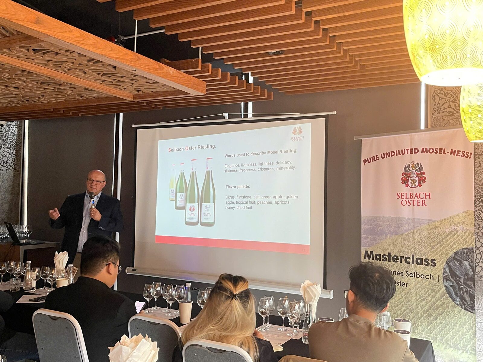 Johannes Selbach presenting a slide about Selbach-Oster Riesling next to a Pure Undiluted Mosel-ness masterclass banner