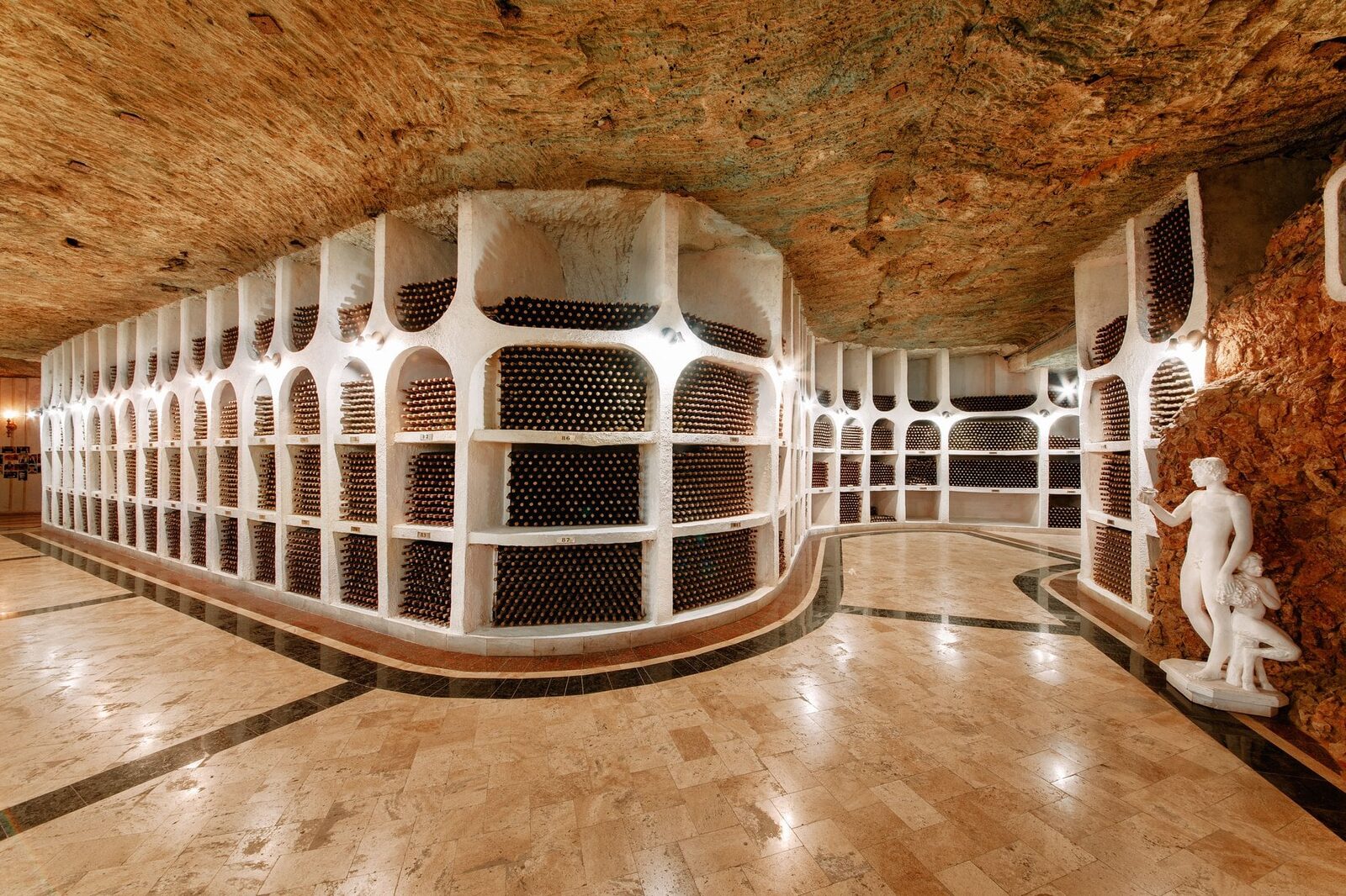 Cricova underground cellar with curved walls of bottle niches and a marble floor